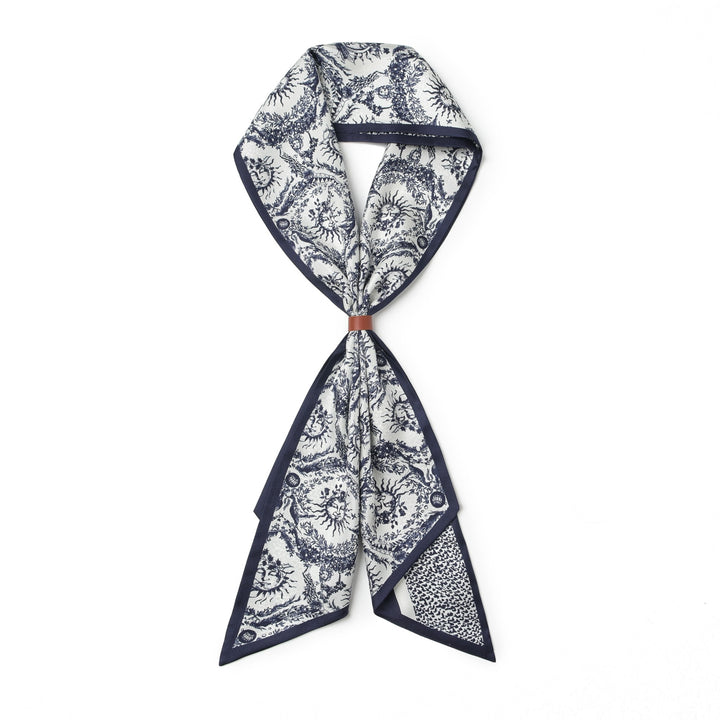 A 16 Momme Affordable Luxury Silk Twill Long Silk Scarf-Gerbera by SusanSilk, featuring intricate black and white designs, folded and secured with a small brown band in the center, crafted from luxurious susansilk.