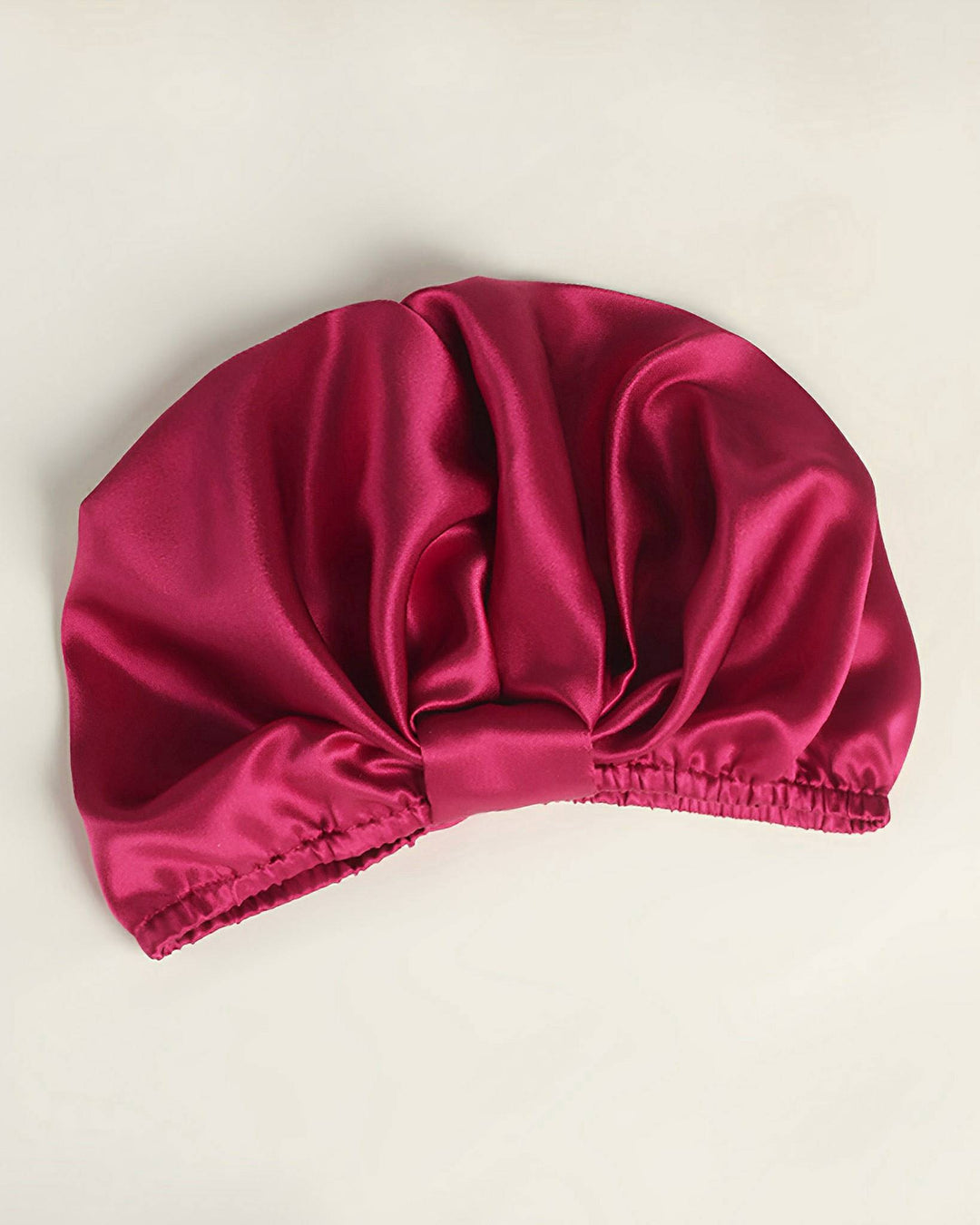 An Elegant Pleated Silk Bonnet For Sleeping in vibrant red, featuring gathered elastic edges and crafted from the finest SusanSilk, displayed on a white background.