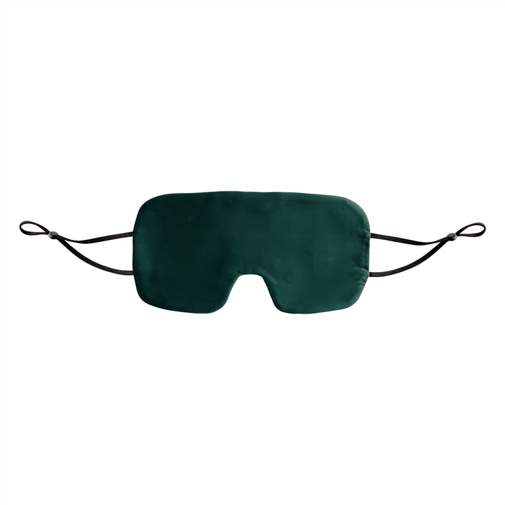 The Oversized Silk Eye Mask by SusanSilk is a dark green silk eye mask with a black elastic strap, designed to cover the eyes.