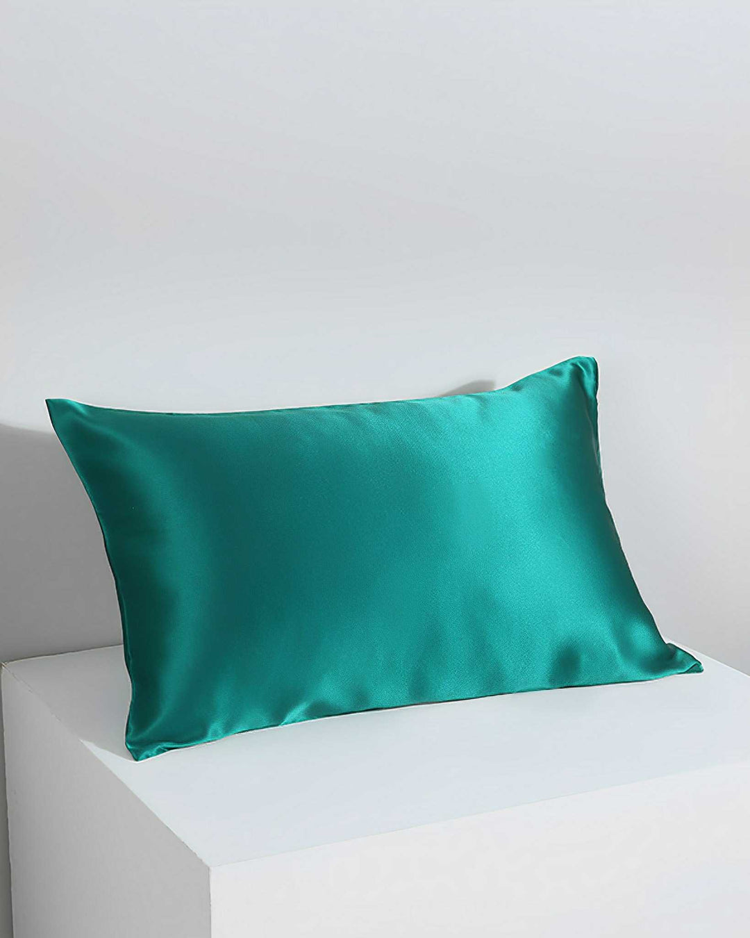 A 19 Momme Silk Pillowcase Zipper by SusanSilk in teal is displayed against a white and light gray background.