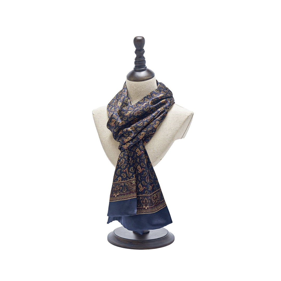 A decorative mannequin displays a luxurious SusanSilk Paisley Series Long Silk Scarf in dark blue silk with an intricate paisley pattern.