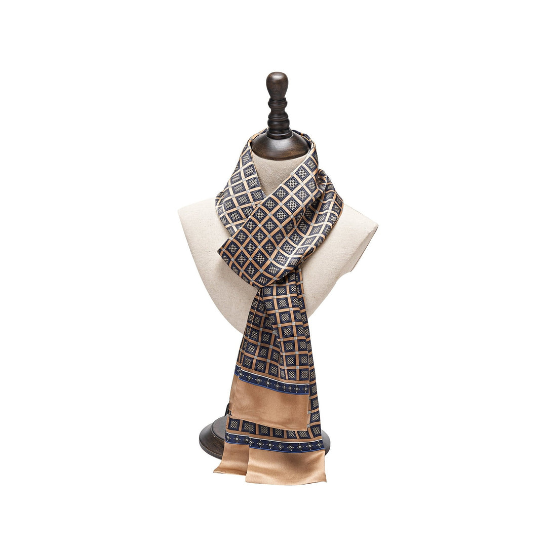 Mannequin displaying a SusanSilk Journey Grid Series Long Silk Scarf with a pattern predominantly featuring brown, blue, and white colors.