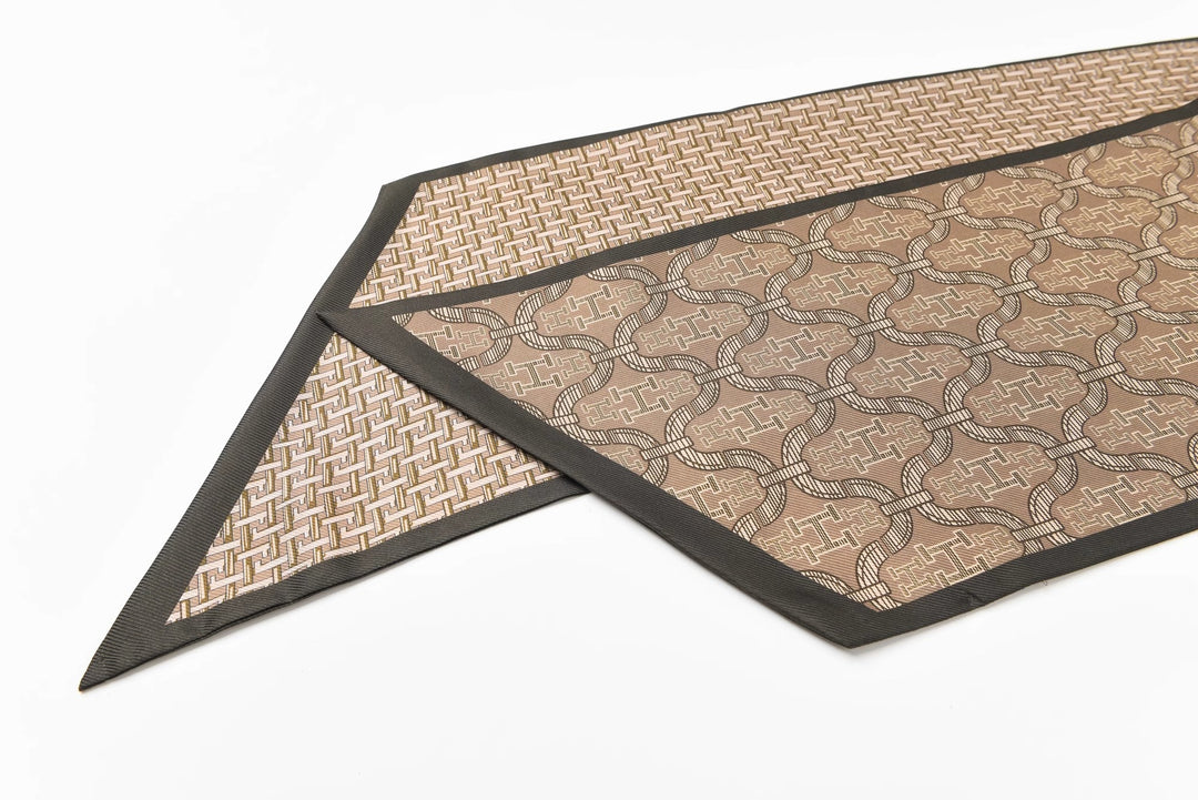 Two intricately patterned 16 Momme Affordable Luxury Silk Twill Long Scarves by SusanSilk are layered, showcasing geometric and lattice designs in brown tones with dark borders, laid out on a white surface.