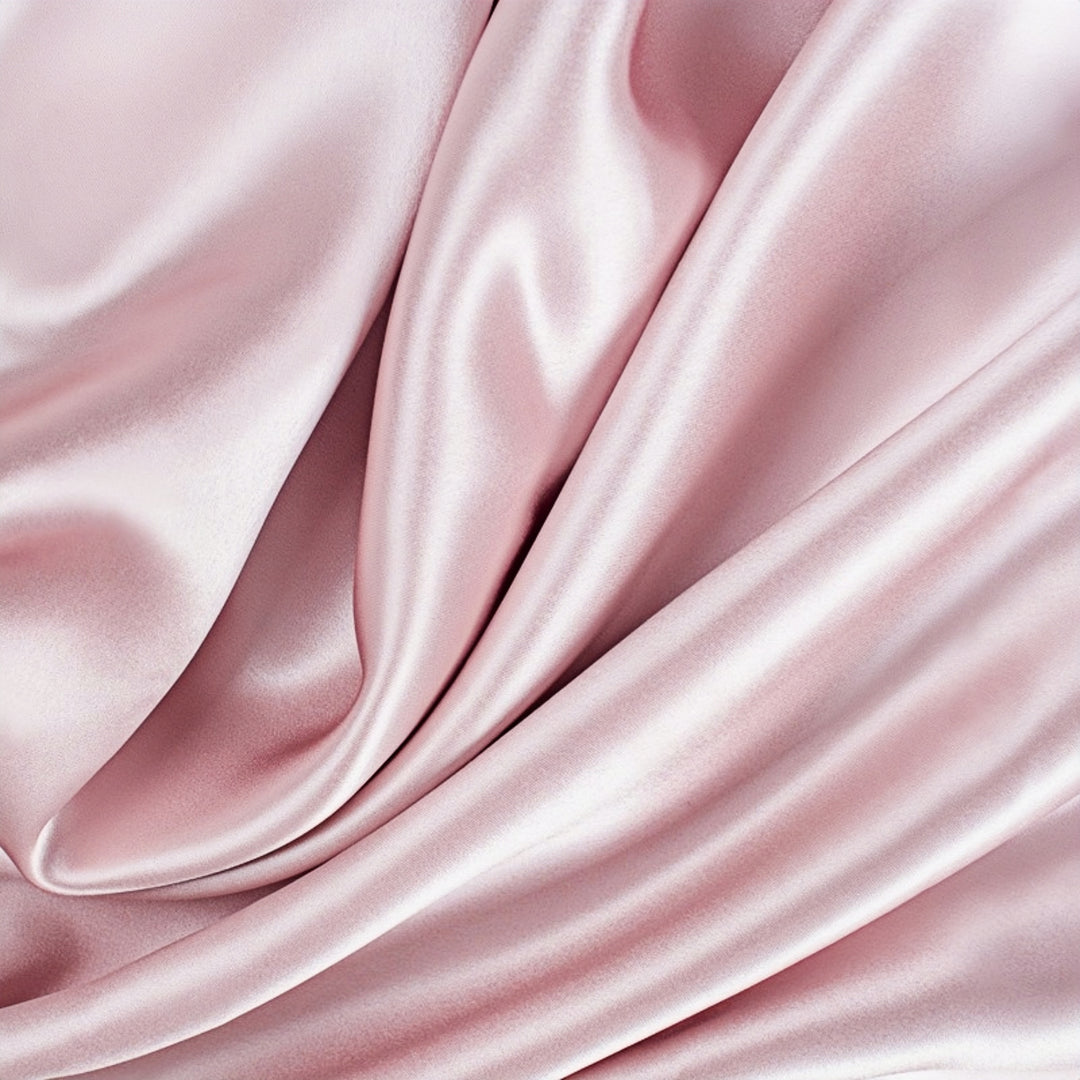 Close-up of the SusanSilk 22 Momme High Gloss Silk Pillowcase Envelope showcasing its smooth, flowing folds and lustrous finish in a soft pink hue.