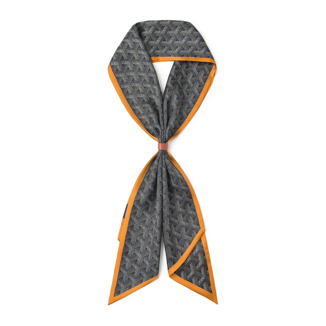 The 16 Momme Affordable Luxury Silk Twill Long Silk Scarf-Cubic Orange by SusanSilk features a gray patterned background with an orange trim, crafted from luxurious silk and elegantly tied in a decorative knot.