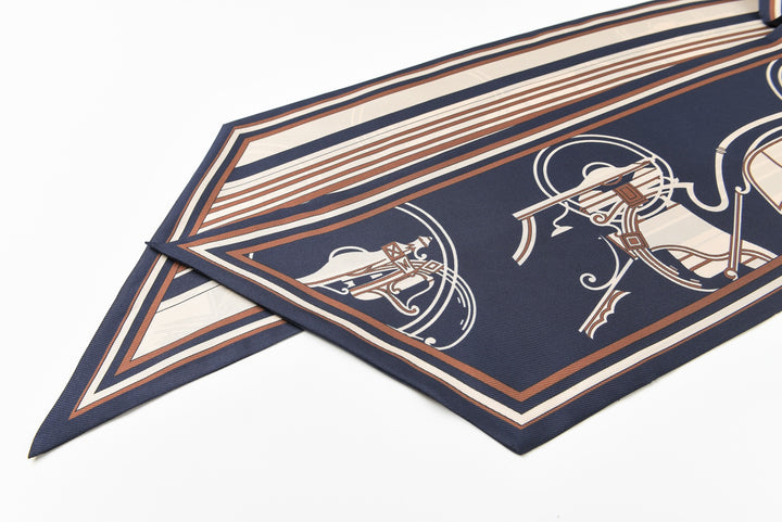 Close-up of the 16 Momme Affordable Luxury Silk Twill Long Silk Scarf-Blue Striped Wagon by SusanSilk, showcasing intricate patterns with lines and geometric designs in shades of blue, beige, and brown.