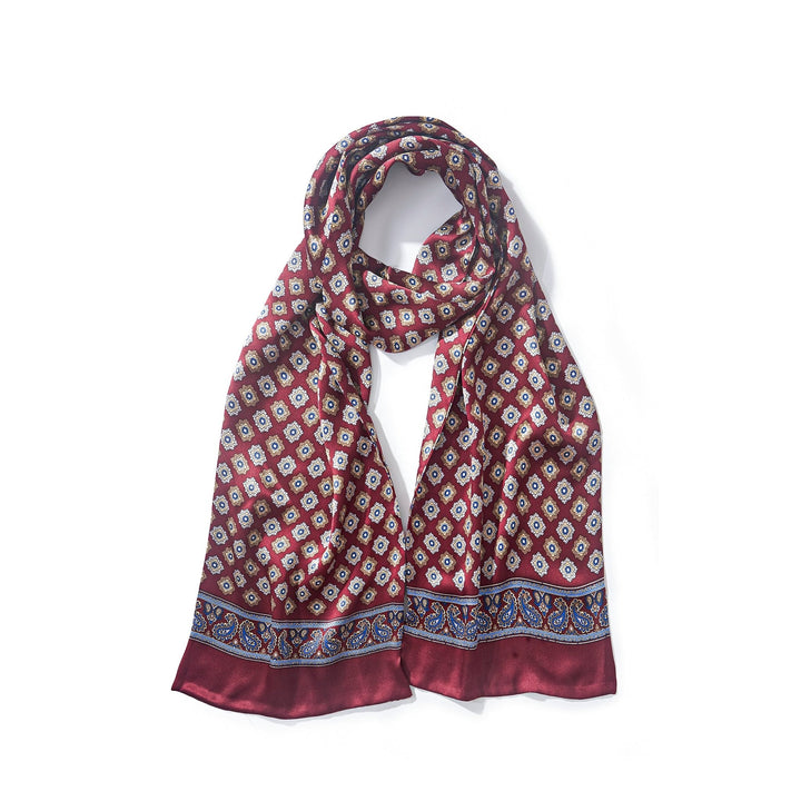 A SusanSilk Geometric Pattern Long Silk Scarf featuring a maroon base adorned with a white and blue diamond-shaped pattern, and complemented by blue and maroon borders at the ends.