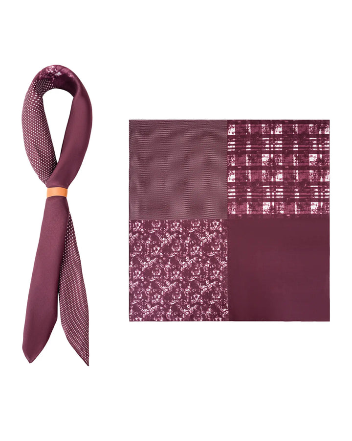 A Straits Red Square Silk Scarf from SusanSilk, featuring four distinct patterns—solid, checkered, floral, and micro dots—is coiled into a knot alongside a burgundy silk tie with white polka dots.