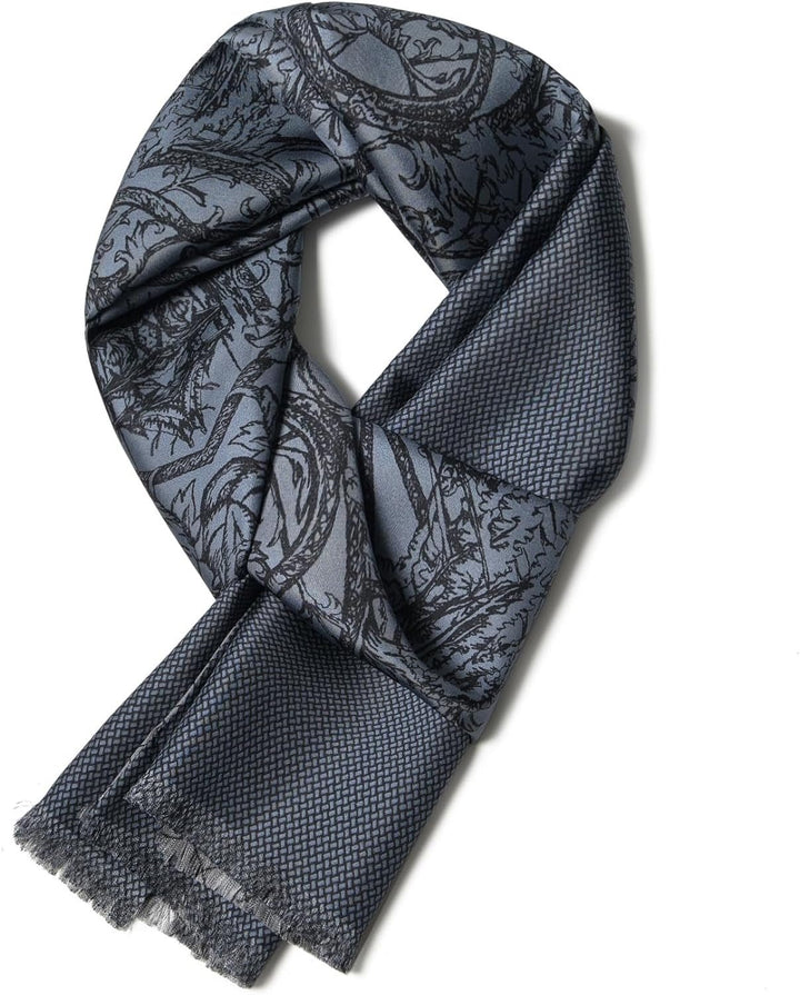 A folded Luxurious Men's Silk Twill Scarf - Gentleman Gray by SusanSilk, featuring an intricate black pattern and fringed edges, displayed against a white background.