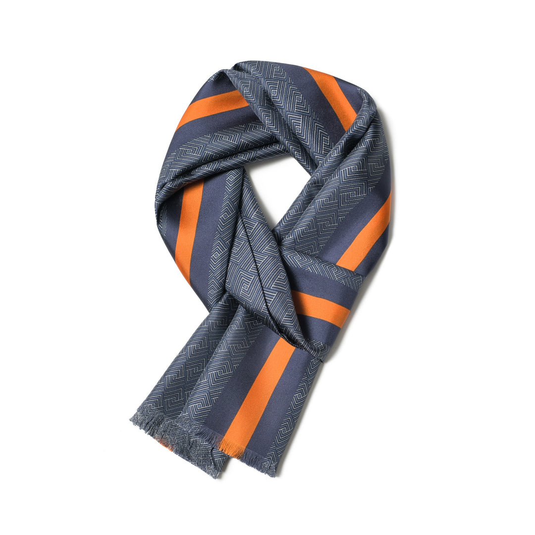 A silk twill scarf from SusanSilk, in blue and yellow, featuring a subtle geometric pattern with two orange and navy vertical stripes down the center.