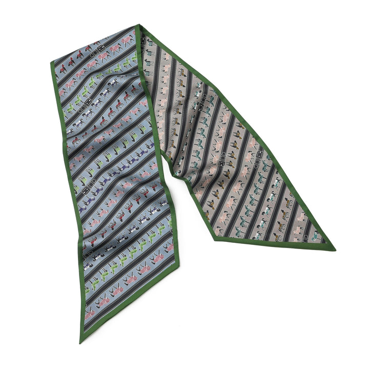 The "16 Momme Affordable Luxury Silk Twill Long Silk Scarf-Green Pony" from SusanSilk is a long, narrow silk scarf featuring various colorful animals and green edges, designed with a geometric shape and pointed ends.