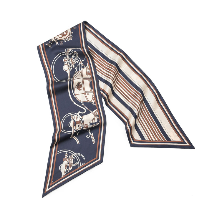 The SusanSilk 16 Momme Affordable Luxury Silk Twill Long Silk Scarf-Blue Striped Wagon is a narrow, pointed scarf in dark blue, adorned with an elegant design featuring equestrian and geometric patterns in brown, white, and beige. Crafted from luxurious silk twill, this accessory adds a touch of elegance to any outfit.