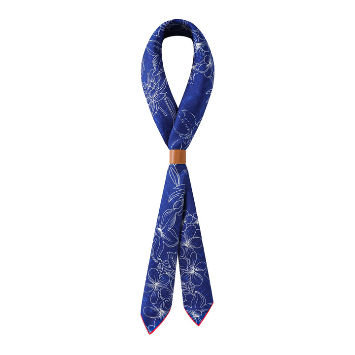 A luxurious Deep Blue Square Silk Scarf from SusanSilk, featuring white floral patterns and adorned with a brown band at the knot and red trim at the ends, displayed on a white background.