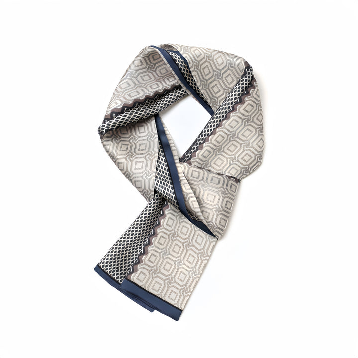 A folded SusanSilk Korean Style Silk Long Fluttering Belt featuring a geometric pattern in shades of beige, gray, and navy blue set against a white background.