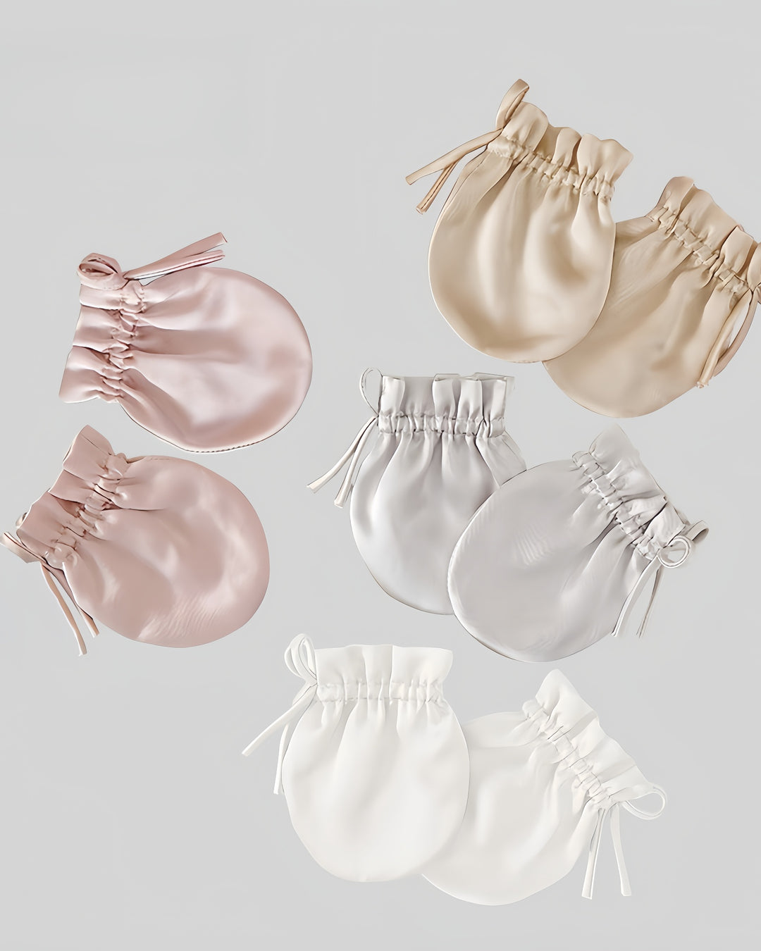 A set of SusanSilk’s 19 Momme Baby Silk Gloves Anti-Face Grabbing, featuring a variety of pastel colors, elegantly displayed on a simple backdrop.