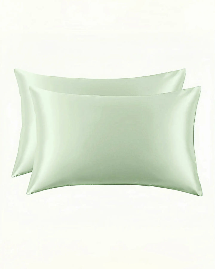 Two New Arrival 25 Momme Beauty Silk Pillowcase Zippers, in light green and crafted from luxurious SusanSilk, are shown side by side against a plain white background.