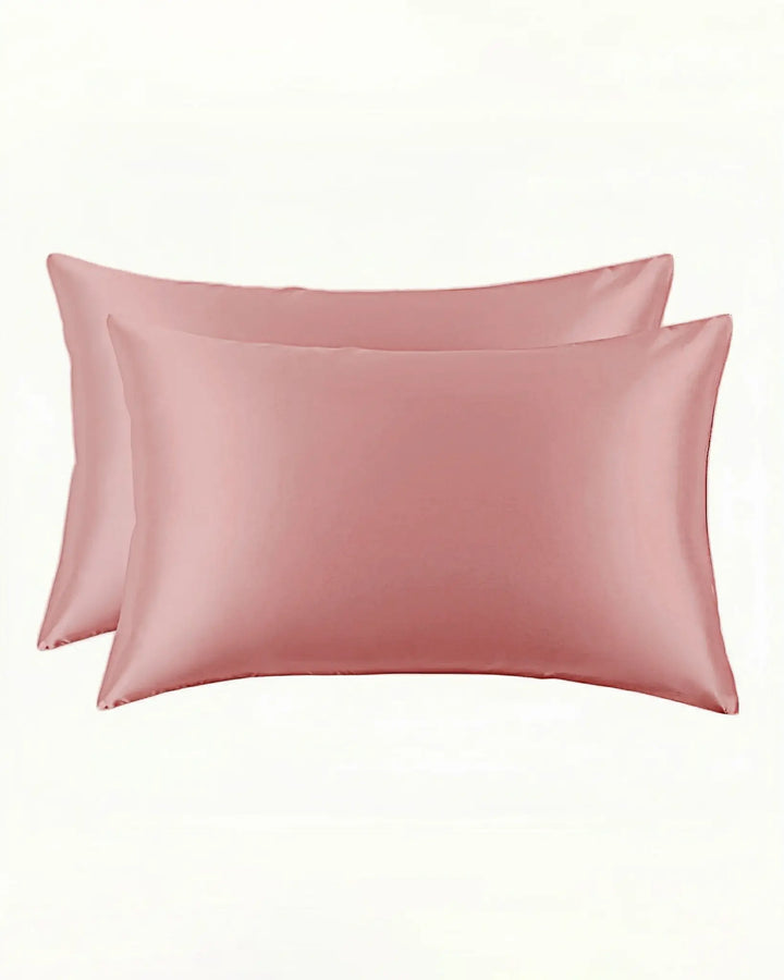 Two pink New Arrival 25 Momme Beauty Silk Pillowcase Zippers, crafted from luxurious SusanSilk, are displayed side by side against a plain white background.