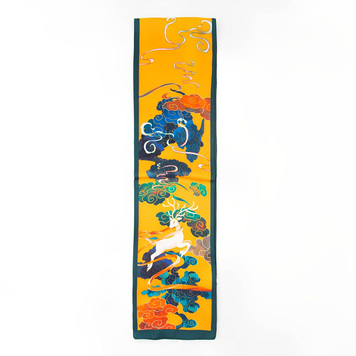 The Fairy Deer Long Mulberry Silk Scarf by SusanSilk is a long, narrow silk accessory featuring colorful illustrations of clouds, swirls, and a mythological creature on a yellow background.