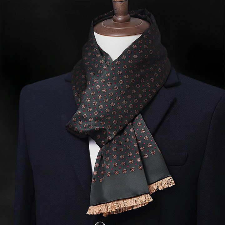 A black mannequin is dressed in a dark suit and adorned with the SusanSilk Geometric Series Long Silk Brushed Scarf, featuring a black and red polka dot design with beige tassels at the ends.