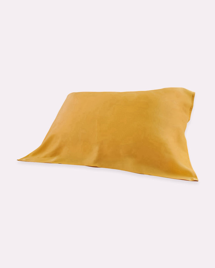 The 19 Momme Baby & Toddler Silk Pillow Cover by SusanSilk, in a vibrant yellow shade, is shown on a white background. Made from 100% silk and featuring eco-friendly reactive printing, it promises natural and cozy sleep.