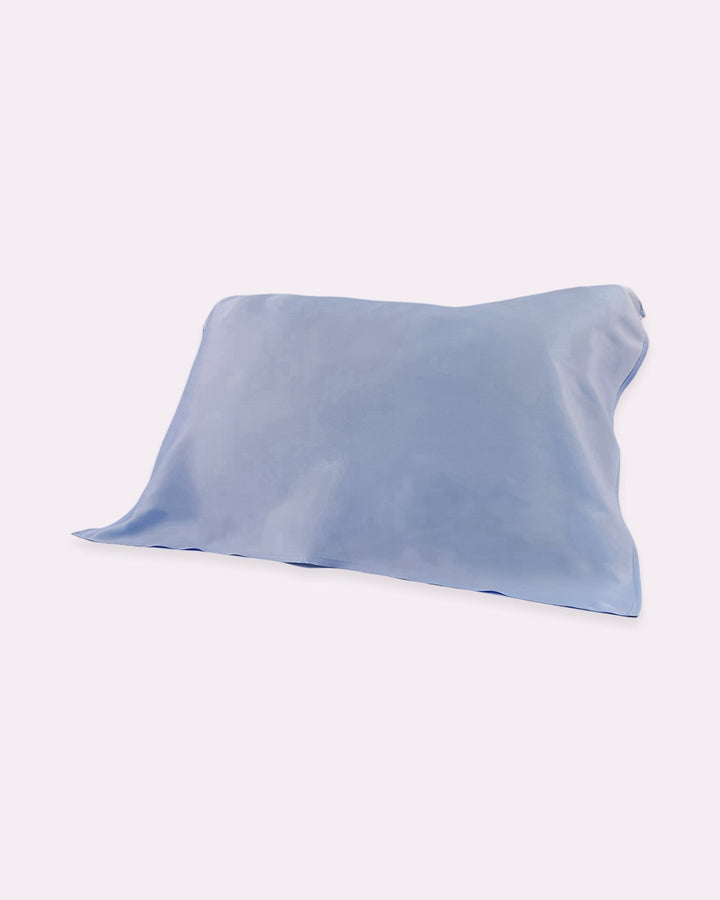 The 19 Momme Baby & Toddler Silk Pillow Cover from SusanSilk, in a beautiful Sky Blue Cerulean color and crafted entirely from 100% silk for a natural and cozy sleep, is positioned slightly askew on a plain white background.