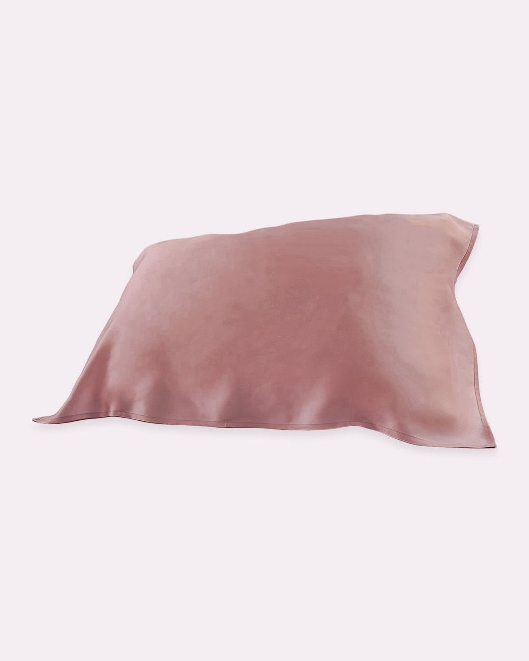 The SusanSilk 19 Momme Baby & Toddler Silk Pillow Cover, in a delicate pinkish beige hue, crafted from 100% silk with eco-friendly reactive printing, rests on a white background, promising a naturally cozy sleep.