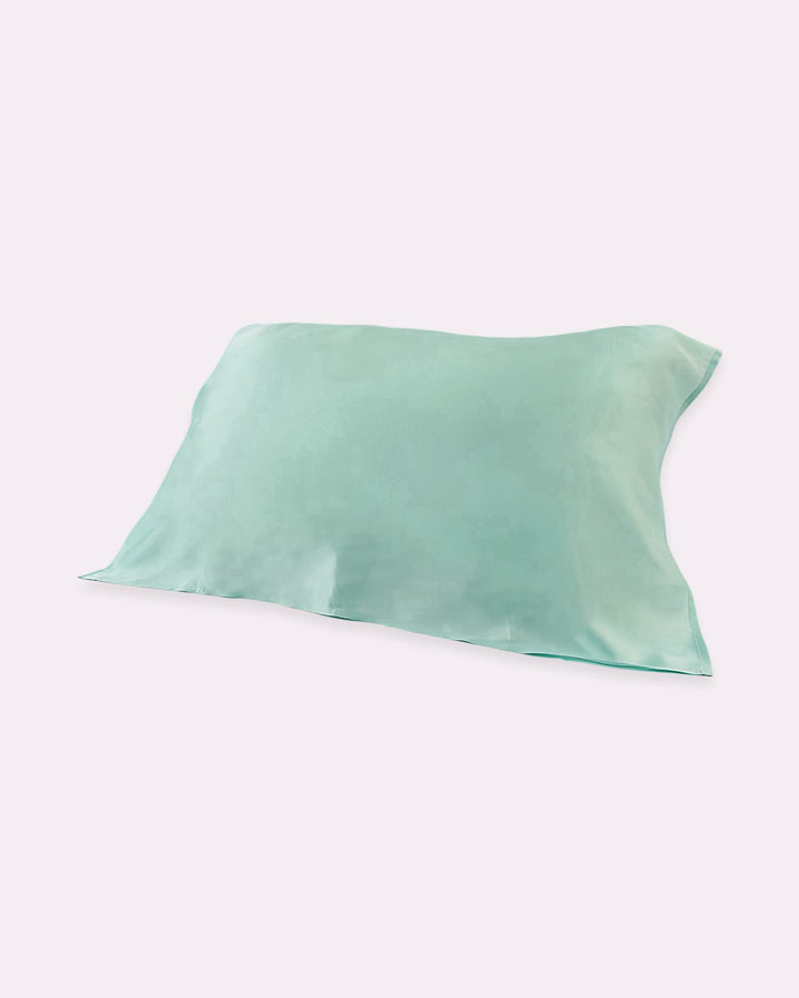 A light sea green pillow cover with a plain design on a white background, the 19 Momme Baby & Toddler Silk Pillow Cover by SusanSilk is made from 100% silk for a natural and cozy sleep experience.