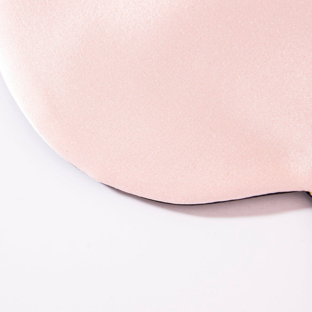 Close-up view of the SusanSilk Earth Tones Double Side Silk Eye Mask in light pink on a white background, showcasing its smooth texture.