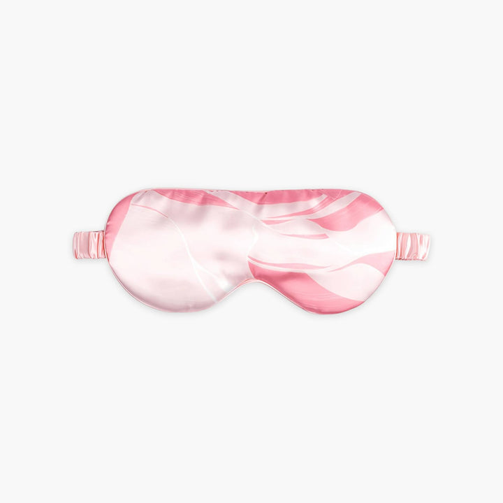 An Elegant Silk Eye Mask - Pink Canyon by SusanSilk, featuring a pink and white marble pattern with an adjustable strap, is displayed on a plain white background.