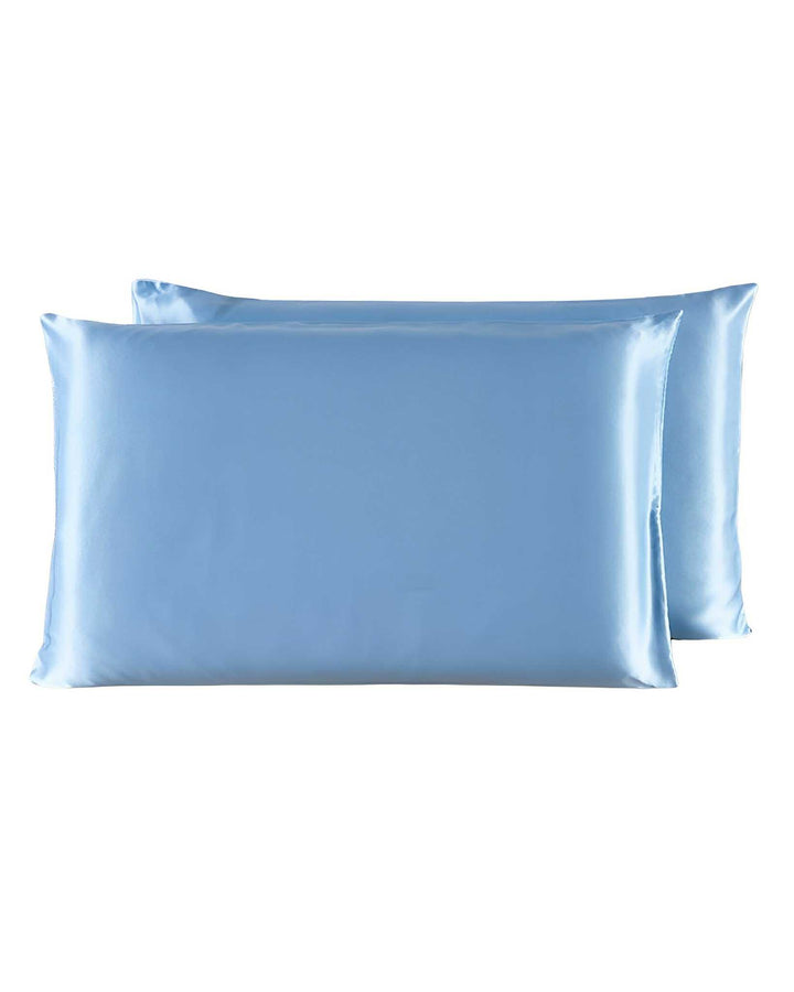 Two SusanSilk 19 Momme Silk Pillowcase Zippers, in a light blue shade and offering the same luxurious feel as satin, are arranged with one slightly overlapping the other against a pristine white background.