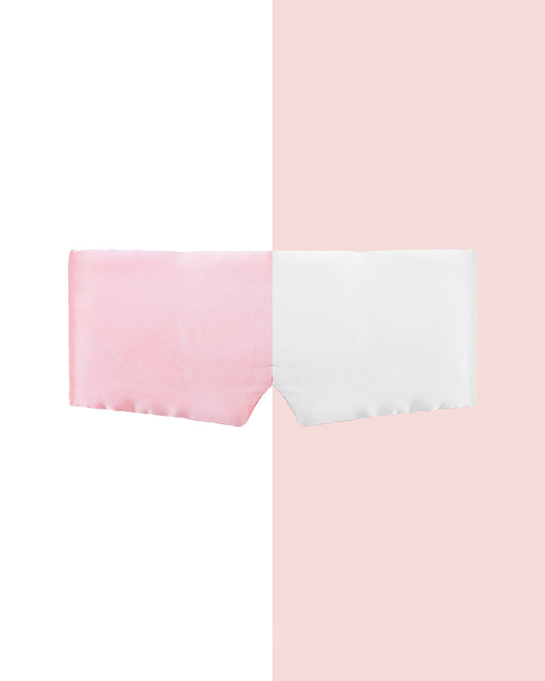 Introducing the Large One Piece Silk Eye Mask by SusanSilk: a luxurious silk accessory divided vertically, showcasing pink on the left half and white on the right, set against a background mirroring these elegant colors.