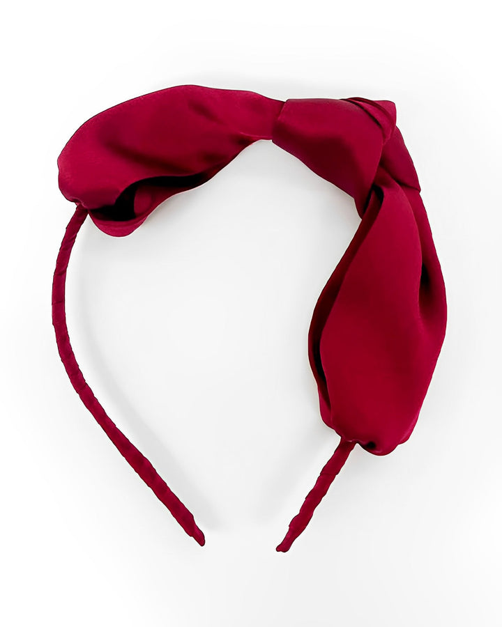 A Pure Color Bow Knot Silk Headband by SusanSilk, featured in maroon with a large bow on top, showcased against a white background.