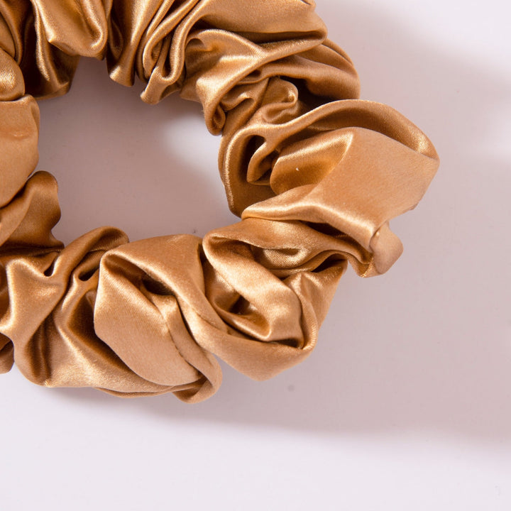 A close-up image of a luxurious 22 Momme silk scrunchie from the SusanSilk Luxury Silk Scrunchies Set 4-Pack on a white background.