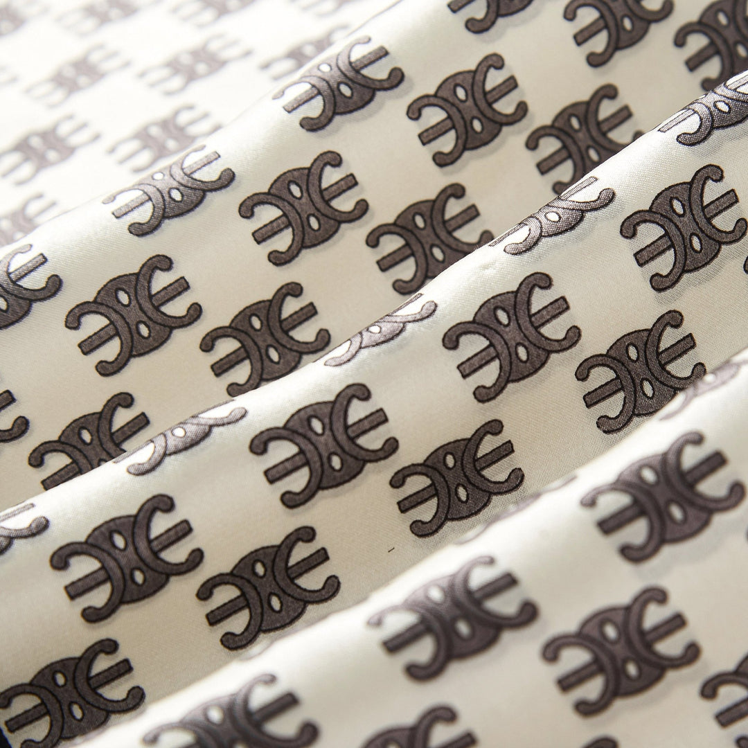 Close-up of the Arc De Triomphe Narrow Long Silk Scarf by SusanSilk, featuring a repeating black and white elephant pattern arranged in rows.