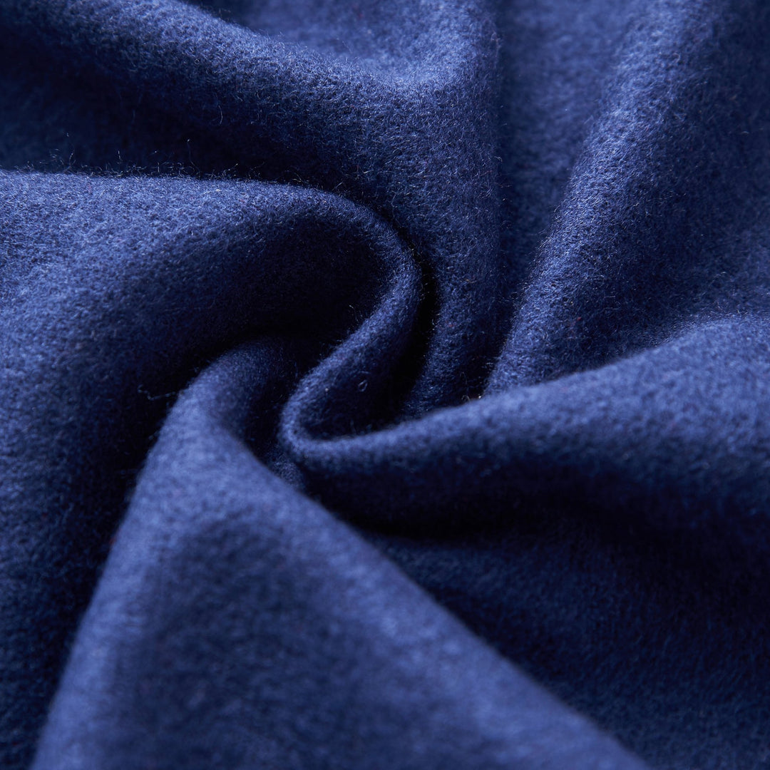 Close-up of a SusanSilk Buckle Pattern Long Silk Brushed Scarf in dark blue, featuring a soft texture and arranged in a twisting pattern.