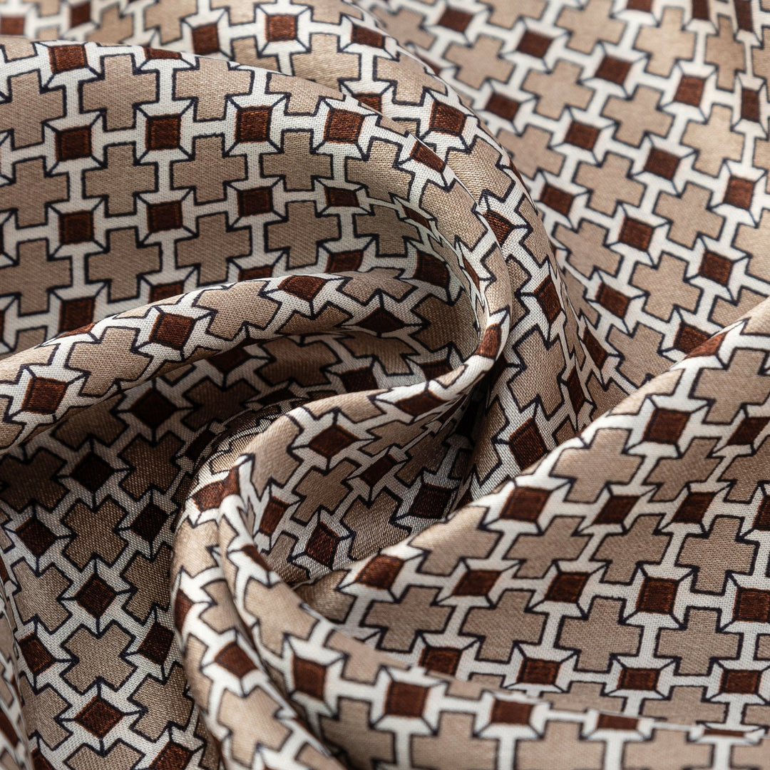 Close-up of the Cross Pattern Long Silk Scarf by SusanSilk, showcasing an intricate geometric pattern in brown and beige tones, with the luxurious material gently gathered.