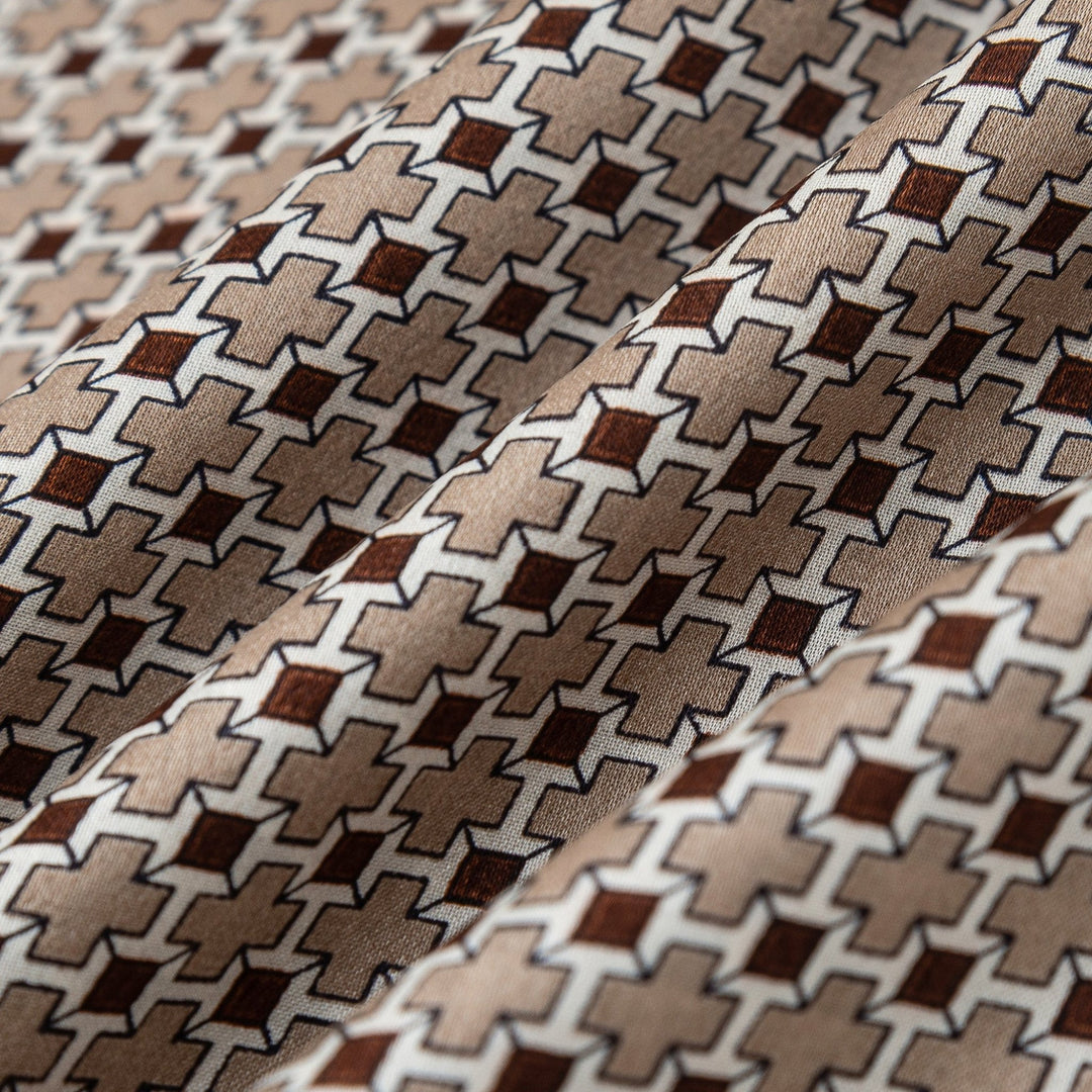 Close-up image of the SusanSilk Cross Pattern Long Silk Scarf showcasing a geometric design with interlocking shapes in shades of brown, beige, and white.