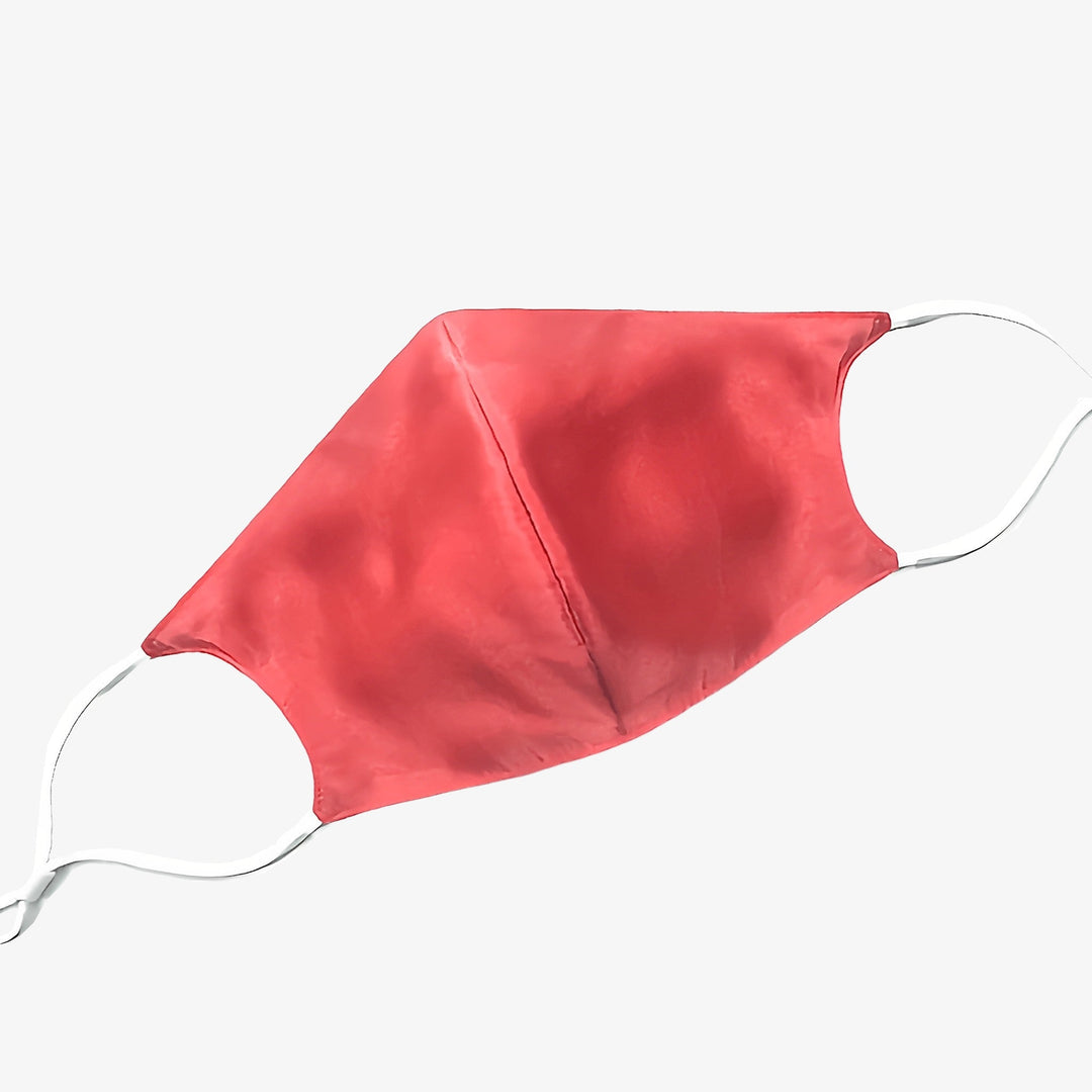 A red face mask with white ear loops, made of luxurious SusanSilk, rests on a plain white background. It is part of the "Double Layer Silk Face Mask with Nose Wire 3 Pcs" collection.