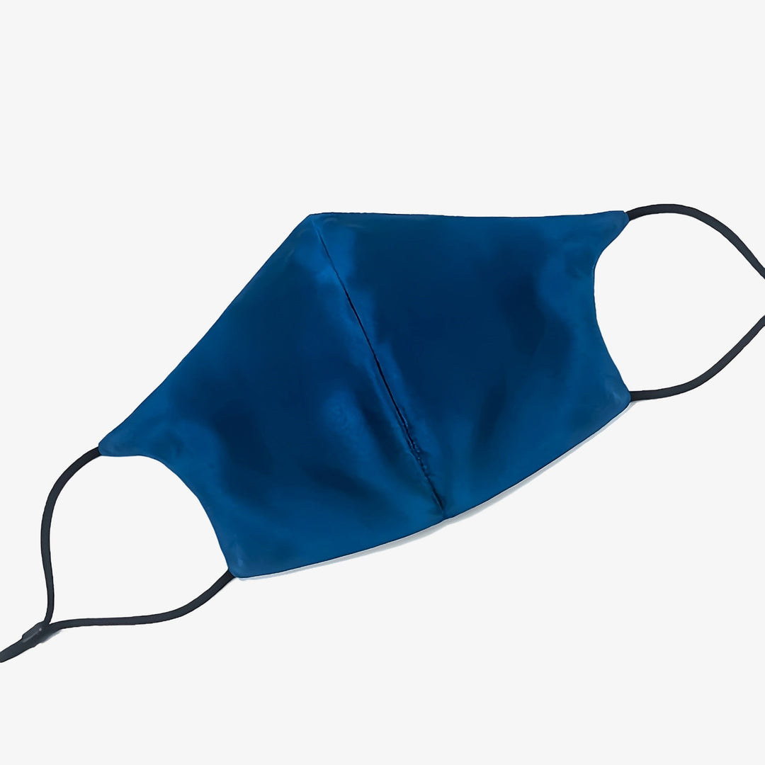 A sleek blue Double Layer Silk Face Mask with Nose Wire from SusanSilk, featuring black elastic ear loops, is displayed on a white background.