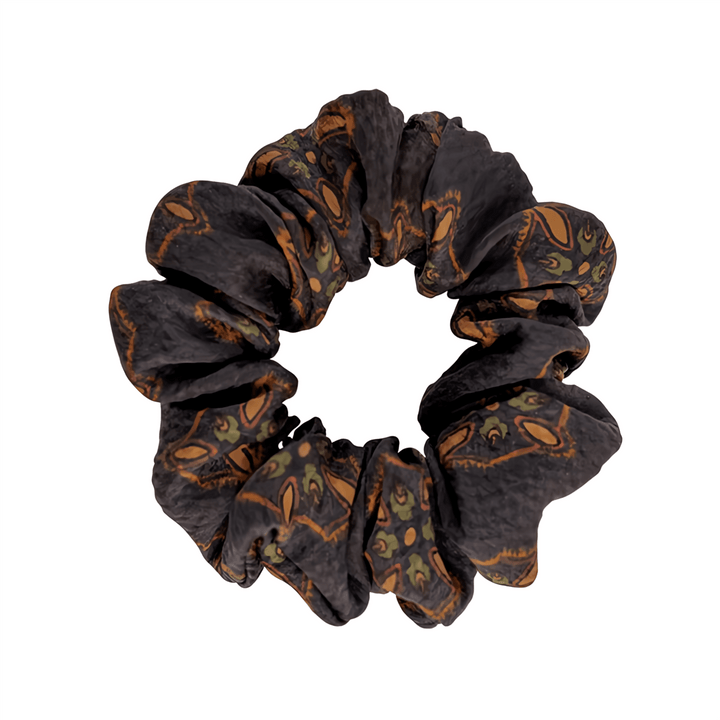 Gambiered Canton Gauze Silk Scrunchie (3cm) by SusanSilk, featuring a black base adorned with an orange and green paisley pattern.