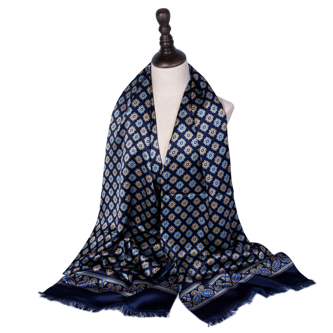 A SusanSilk Geometric Pattern Long Silk Brushed Scarf in blue draped over a white mannequin bust on a wooden stand.