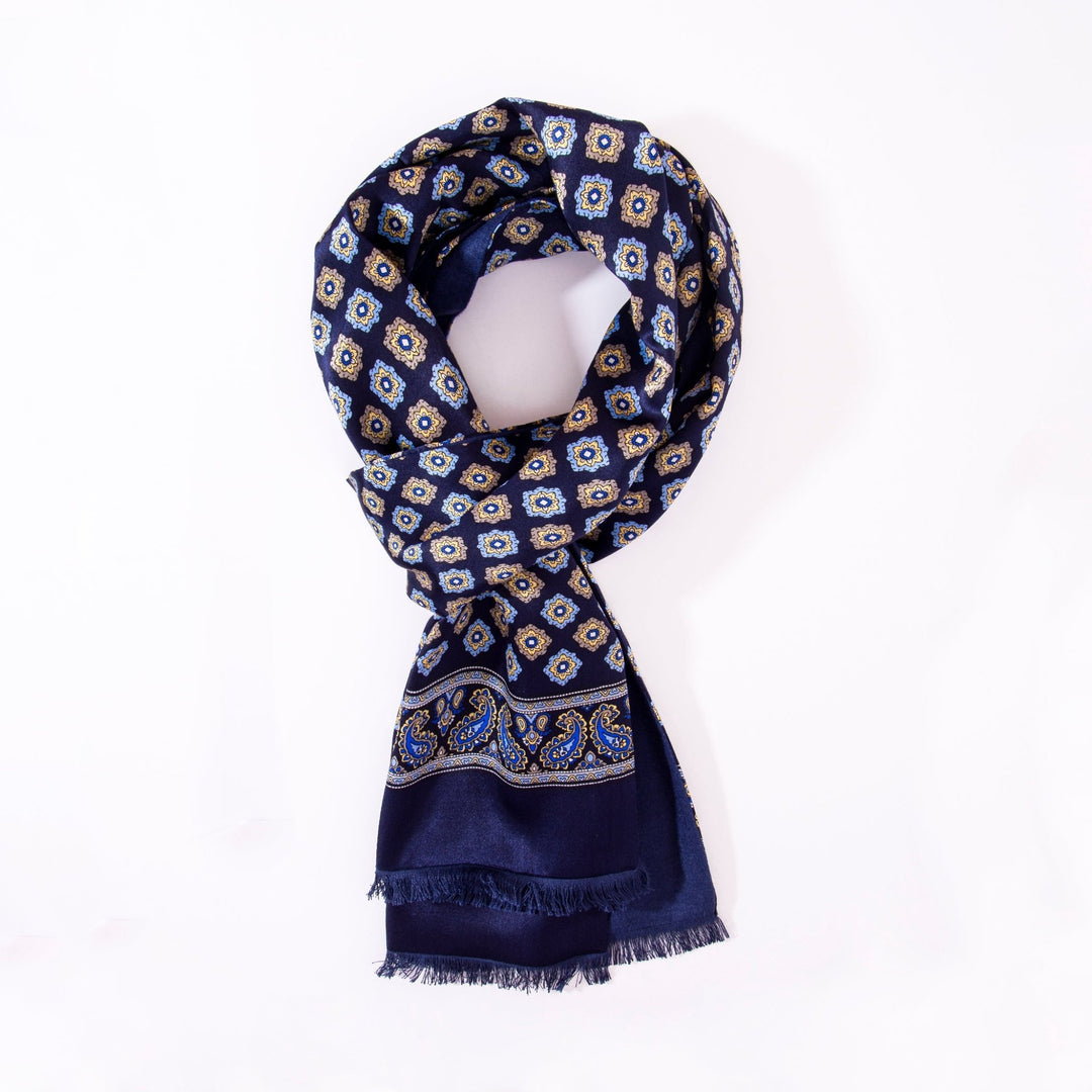 A folded SusanSilk Geometric Pattern Long Silk Brushed Scarf in navy blue with white and gold geometric and paisley patterns on a white background.