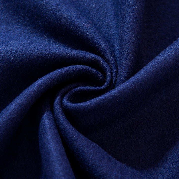 Close-up of the Geometric Pattern Long Silk Brushed Scarf in blue from SusanSilk, swirled into a circular pattern to create a textured, spiraled appearance.