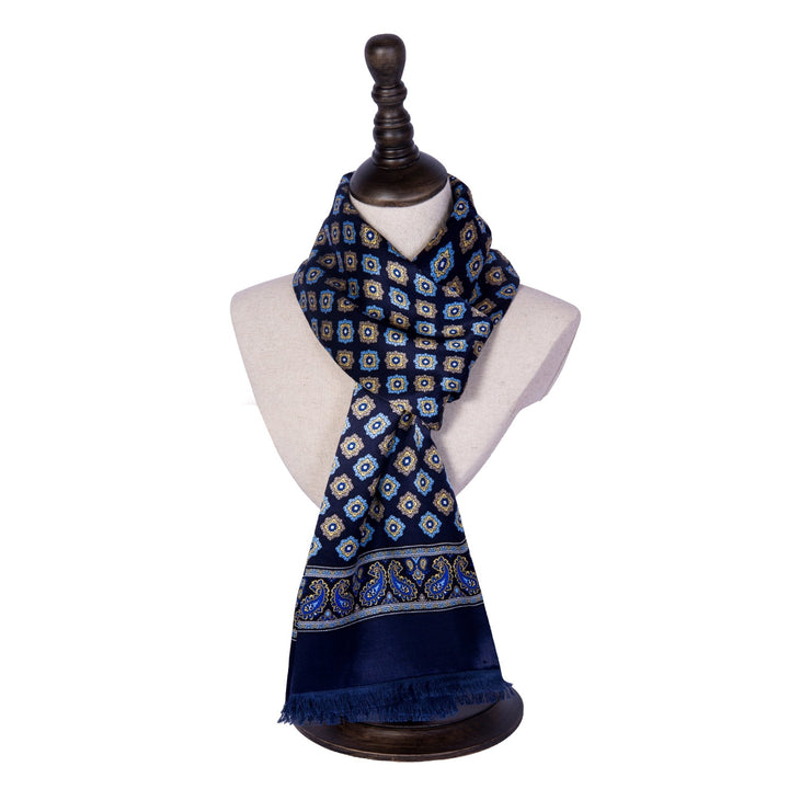 A SusanSilk mannequin displays the Geometric Pattern Long Silk Brushed Scarf in blue, featuring intricate geometric and paisley designs, draped elegantly around the neck.