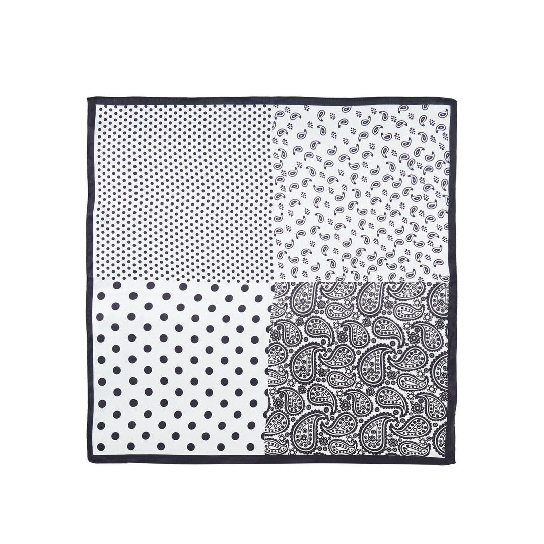 Square silk scarf from SusanSilk's Jigsaw Series, featuring a black border and divided into four quadrants with different black and white patterns: small polka dots, paisley, larger polka dots, and another paisley.