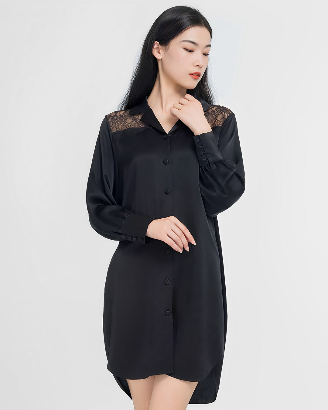 A woman with long black hair wears SusanSilk's Premium Lace Silk Shirtdress, featuring lace detail at the shoulders, standing against a plain white background.