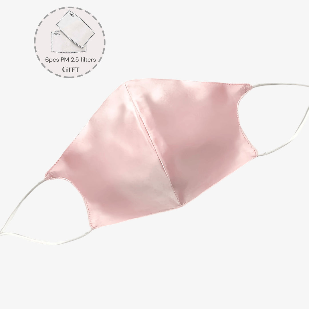 A light pink Double Layer Silk Face Mask with ear loops, part of the SusanSilk collection, is shown along with a circular inset displaying a pack of 6 PM 2.5 filters labeled "Gift." Crafted from high-quality silk, this mask offers both comfort and style.