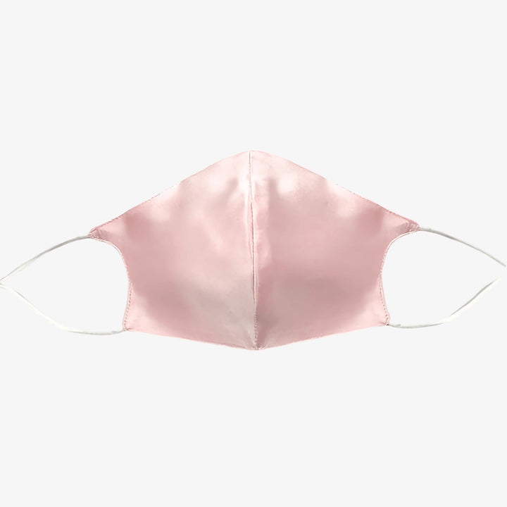 A Double Layer Silk Face Mask with Nose Wire in pink from SusanSilk, featuring white ear loops, displayed against a plain white background.