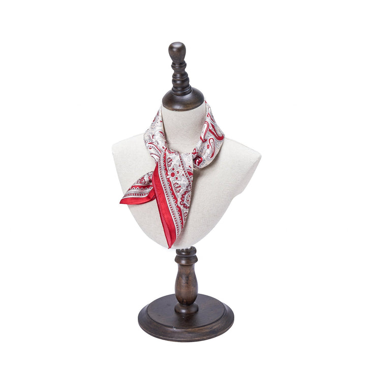 A mannequin bust elegantly displays the Paisley Series Square Silk Scarf, from the luxurious SusanSilk brand, featuring a red and white pattern tied gracefully around its neck.