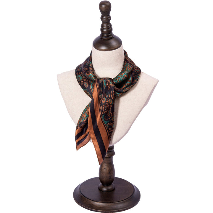 A Paisley Square Silk Scarf - Retro by SusanSilk, featuring brown and black stripes, is displayed on a mannequin bust.